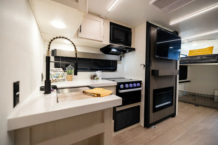 Modern kitchen with black appliances and white countertops