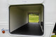 Open door of a recreational vehicle showing a grassy field outside