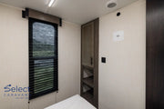 Small bedroom with a window, bed, and wardrobe.