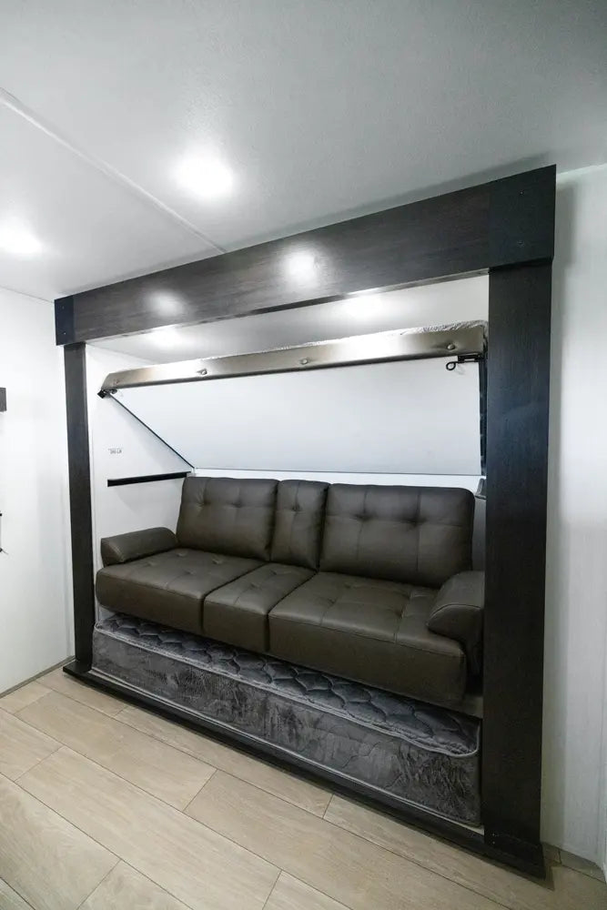 Wall-mounted sofa bed in a compact living space