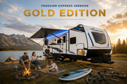 Freedom Express 288BHDS Gold Edition family caravan beside a lake