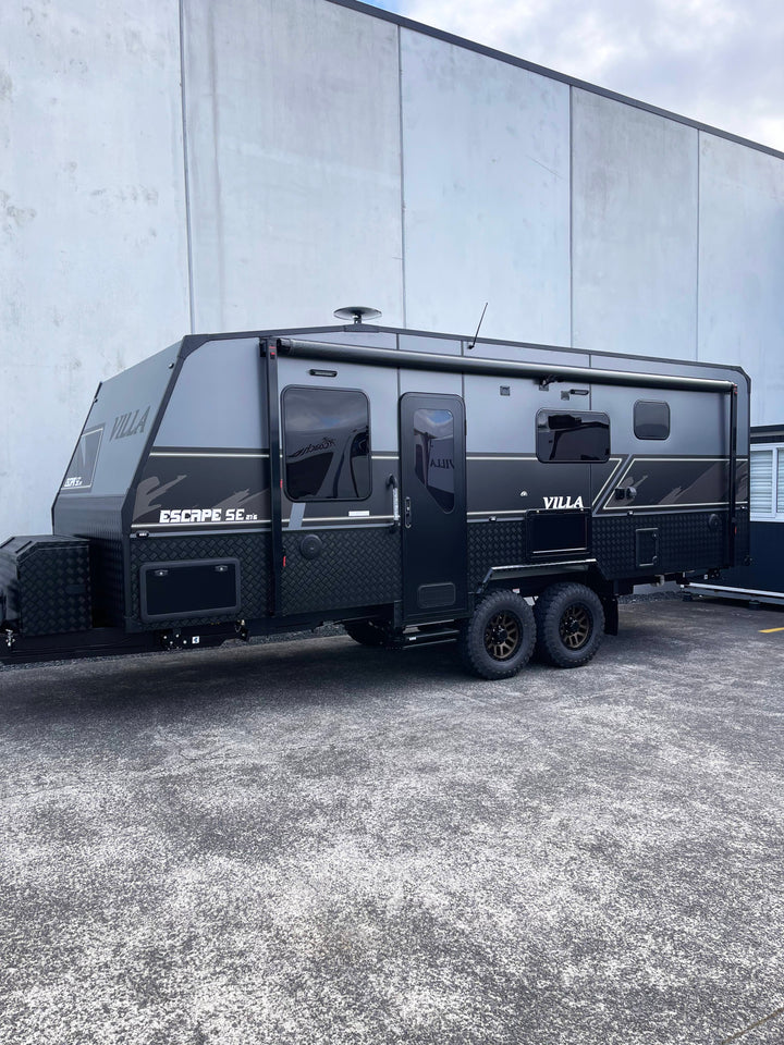 Black Villa Escape SE caravan parked in front of a building