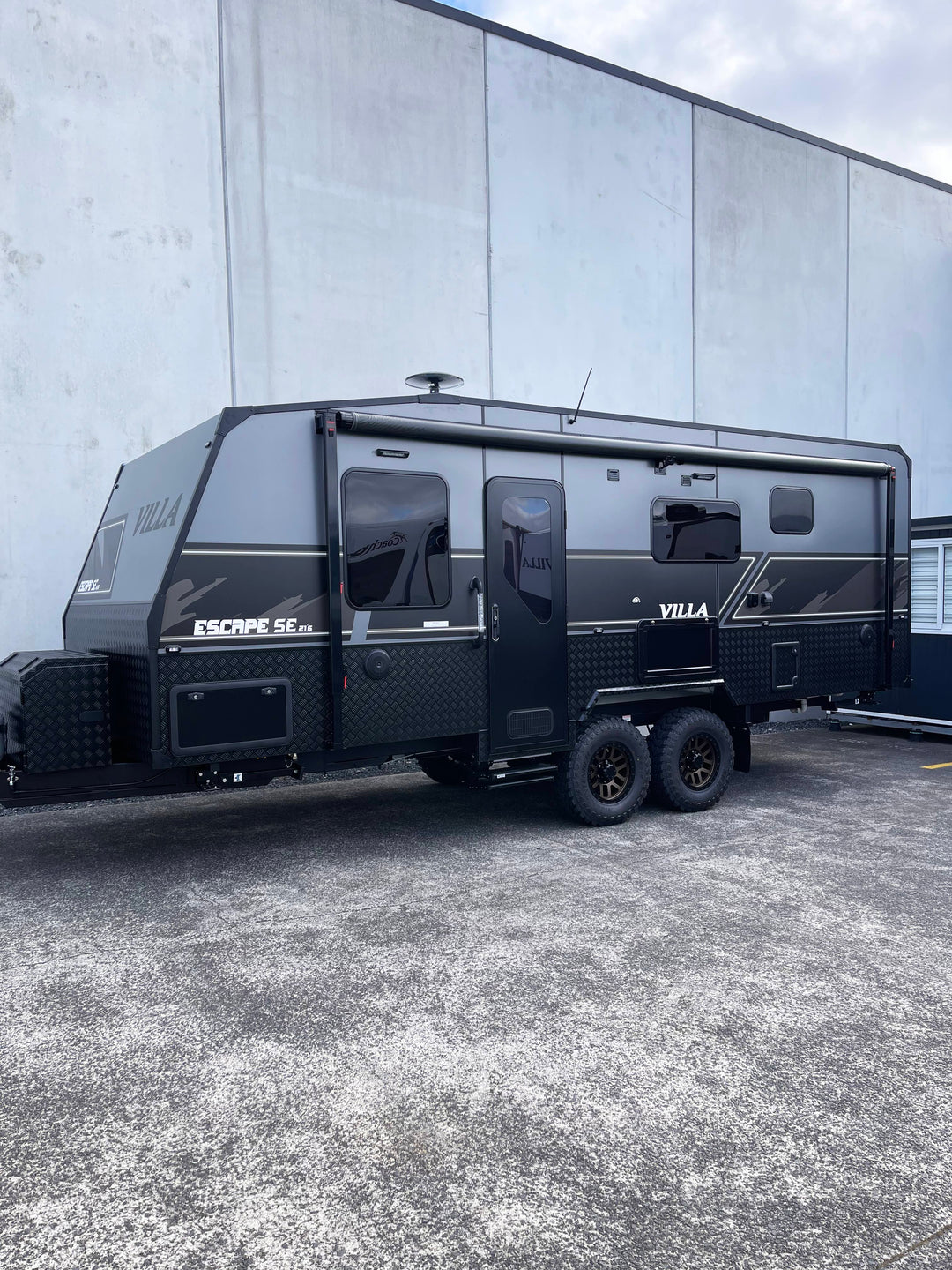Black Villa Escape SE Family caravan 21' 6" parked in front of a building