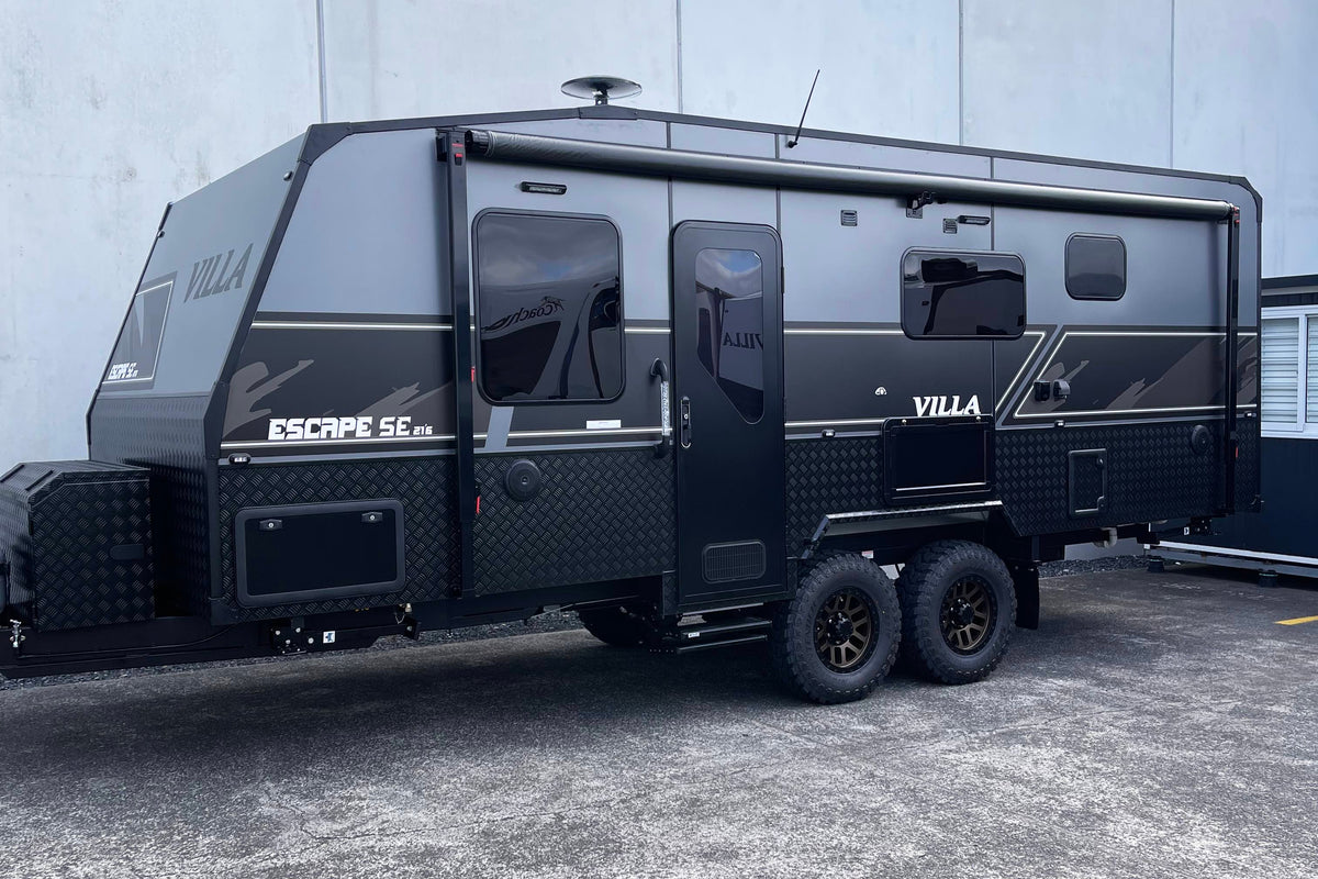 Black Villa Escape SE Family caravan 21' 6" parked in front of a building