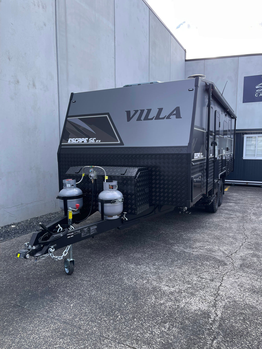 Black Villa caravan parked in front of a building