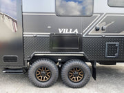 Black and gray caravan with 'Villa' branding on a cloudy day