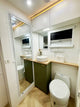 Modern bathroom interior with vanity, mirror, and toilet.