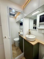 Modern bathroom with vanity, mirror, and toilet