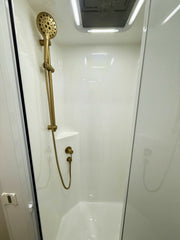 Brass shower head and hose in a bathroom setting