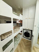 Bunk bed with built-in washing machine in a compact living space