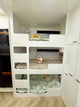 Triple bunk beds with toys in a compact living space