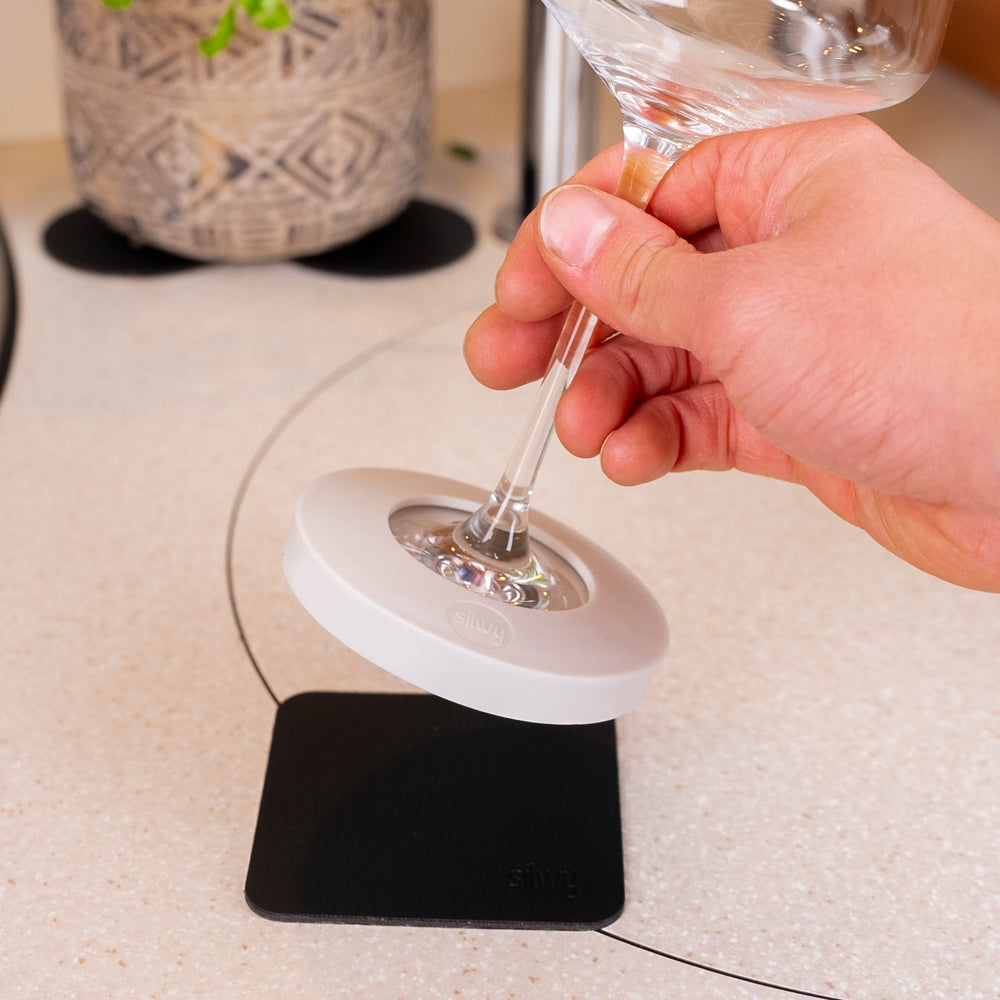 Silwy magnetic adapter fitted to a stemmed wine glass on the included nano-gel pad