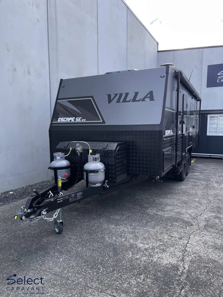 Black Villa caravan parked in front of a building