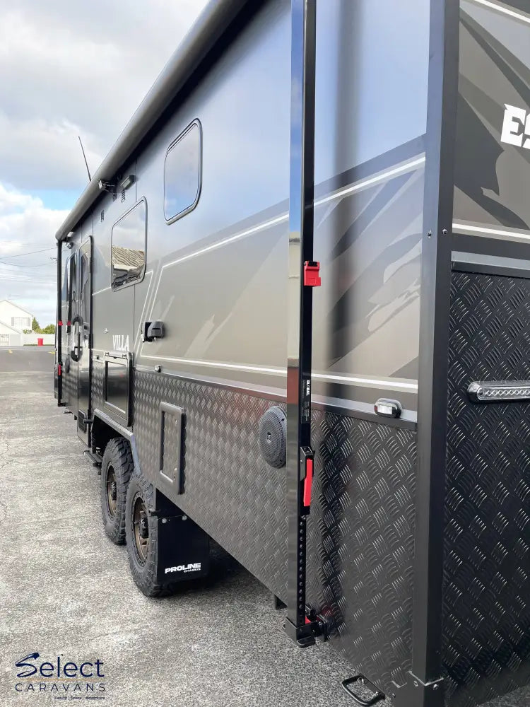 Side view of a large recreational vehicle with a textured door and visible branding.