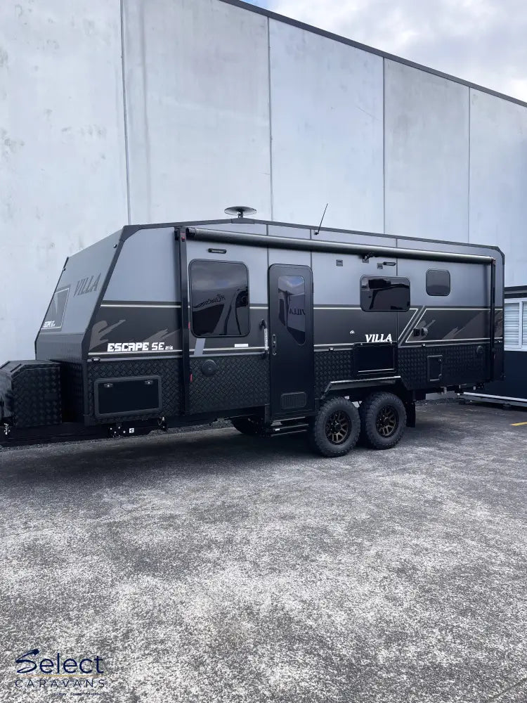Black Villa Escape SE Family caravan 21' 6" parked in front of a building
