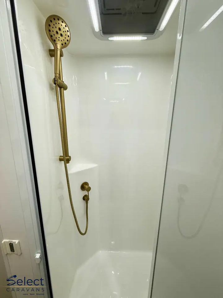 Brass shower head and hose in a bathroom setting
